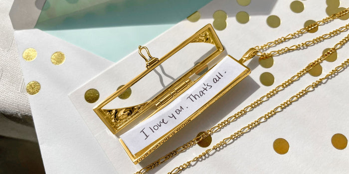 Gold Fortune & Frame locket on top of a thinking of you card.